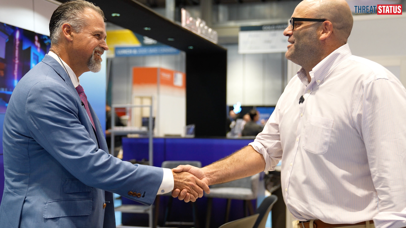 Dale Moore shakes hands with Guy Taylor of Threat Status