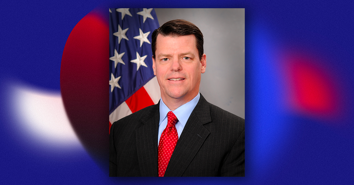 Headshot of James Lackey featuring American Flag